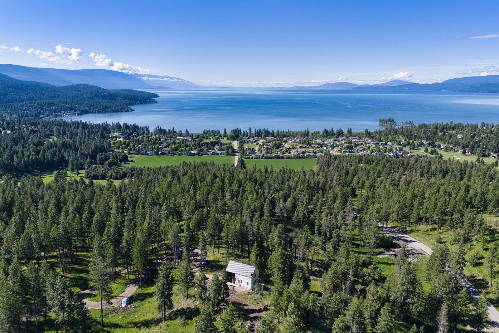 Forested slopes overlooking Flathead Lake and the surrounding mountains